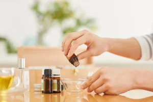 person mixes essential oils for aromatherapy