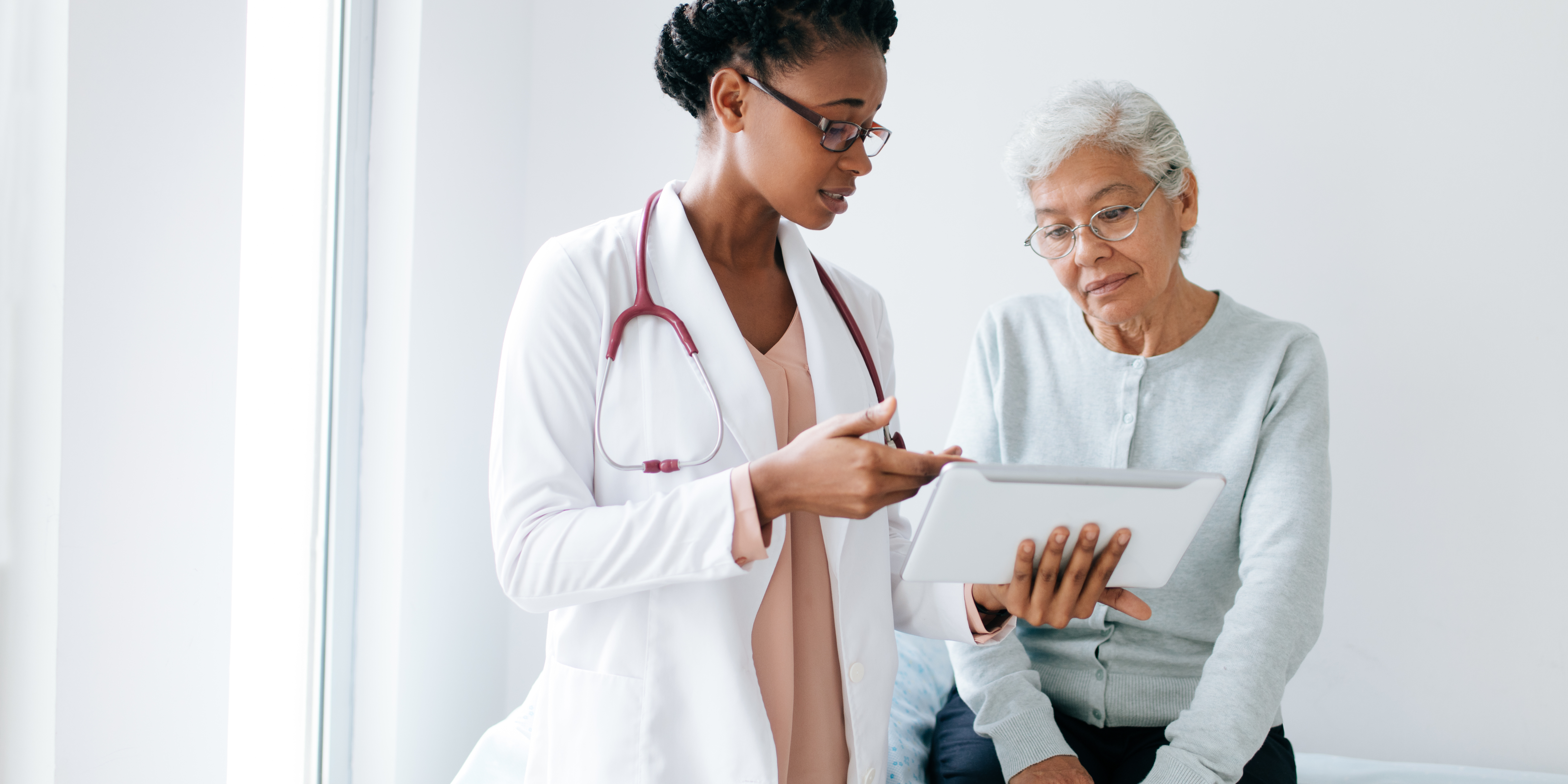 doctor talks with patient in exam room