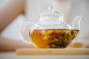 Close up of glass tea pot with herbal tea