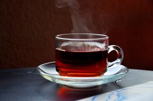 steaming cup of hibiscus tea on saucer