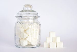 sugar cubes in jar and stacked on table