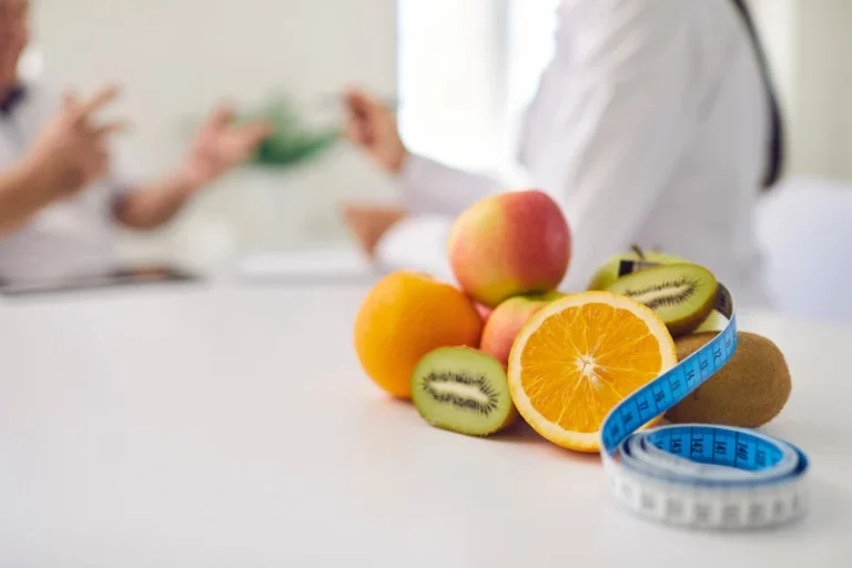 fresh fruit and measuring tape on table