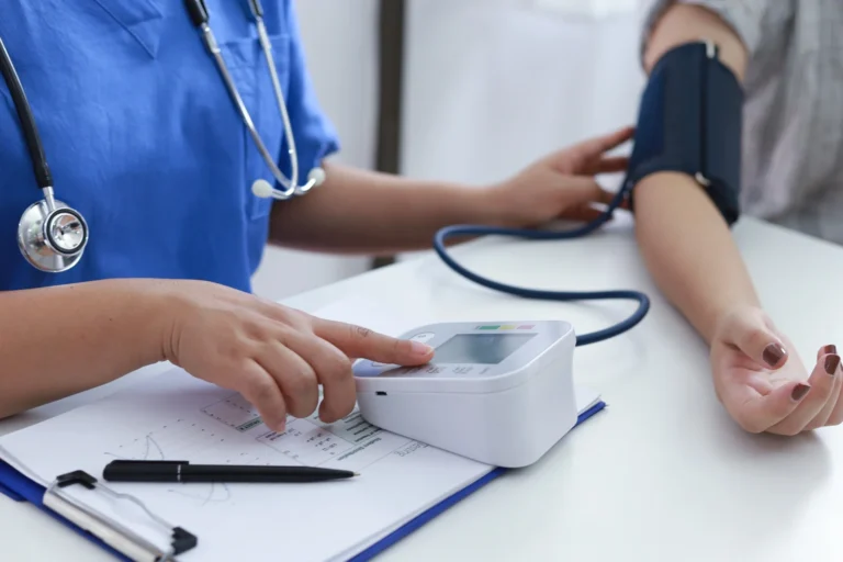 health provider checks patient's blood pressure in office